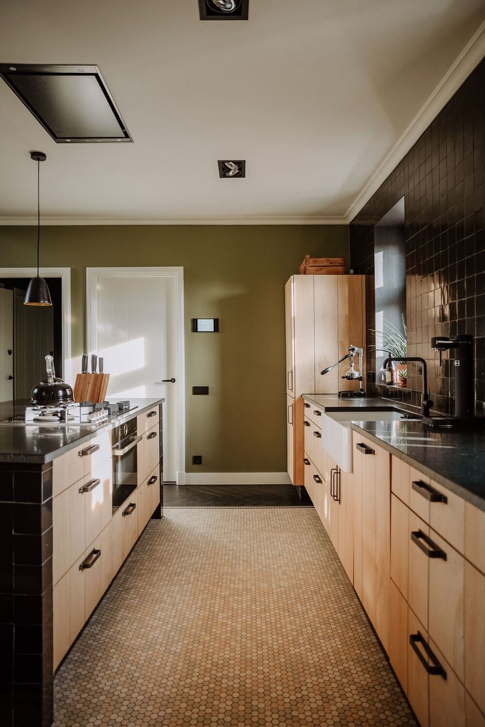 Historic Charm in a New Country House in The Netherlands 9 wooden kitchen cabinets and black tiles