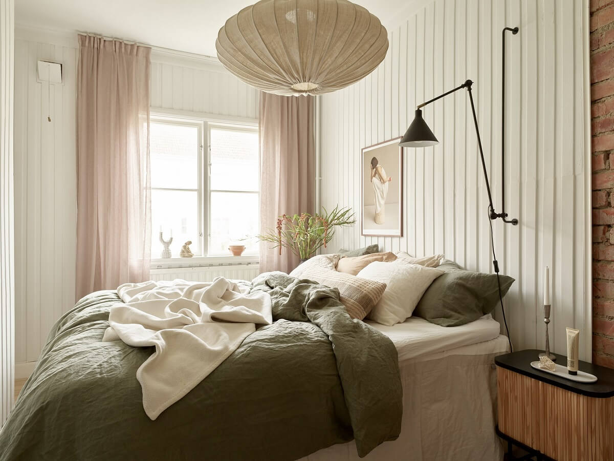 A Swedish Apartment with a Dark Blue Living Room and Exposed Brick 13 wooden wall bedroom green bedding