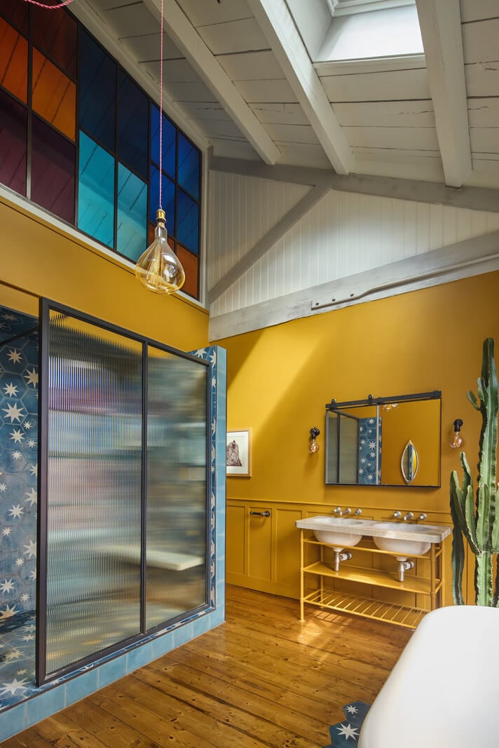 An Industrial and Colorful Warehouse Conversion in London 15 yellow bathroom with stained glass and large shower nordroom