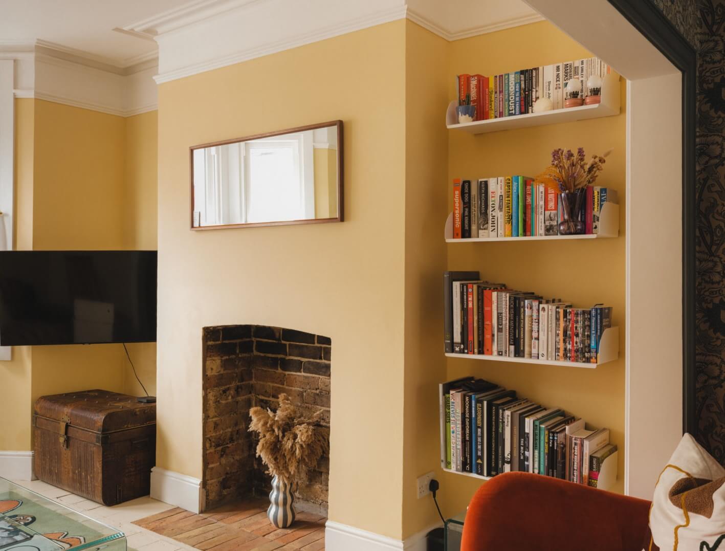 A Charming Victorian House with a Lovely Kitchen 6 yellow living room bookshelves