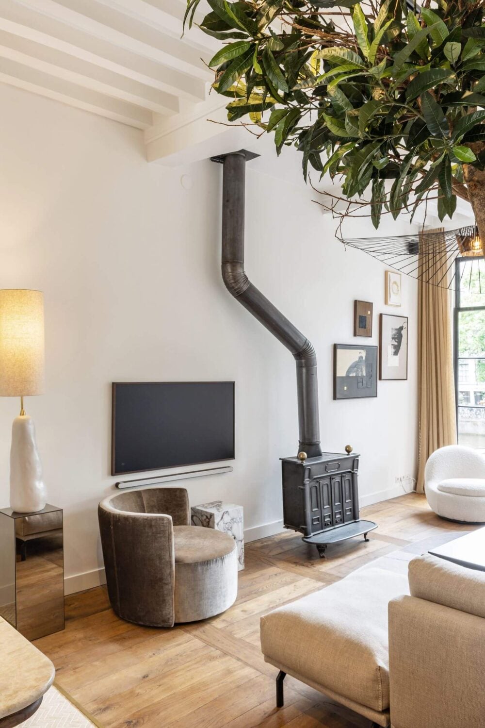 Hotel-Style Interiors in an Amsterdam Canal House 4 amsterdam living room wooden floor exposed beams