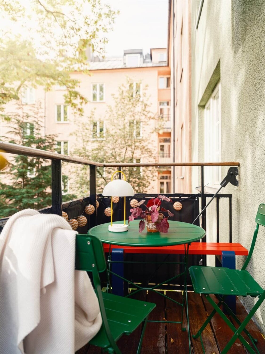 Colorful and Light Rooms in a Swedish One-Bedroom Apartment 11 balcony with green bistro seating