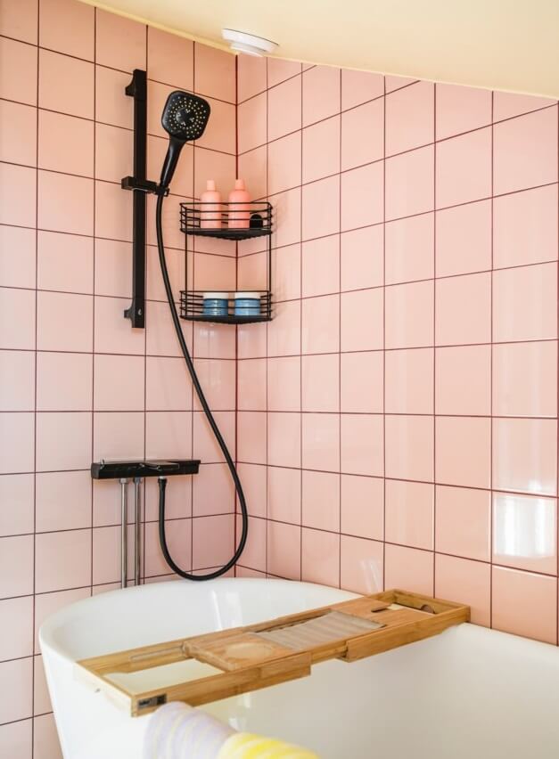 A Small, Colorful Attic Apartment with A Yellow Kitchen 23 bathroom pink tiles black fittings