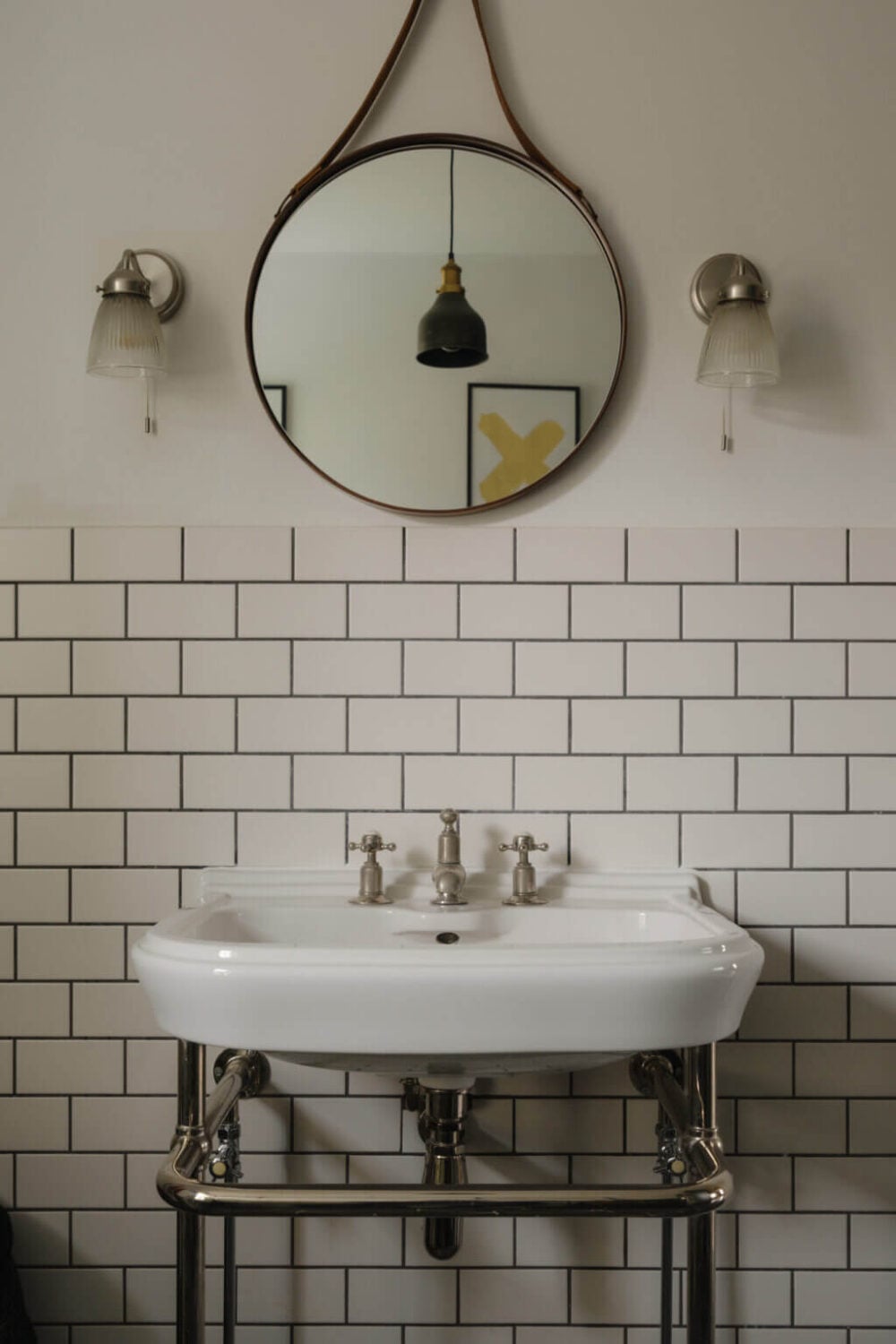 Nature-Inspired Colors in an Extended East London Home 18 bathroom sink with round mirror and white tiles
