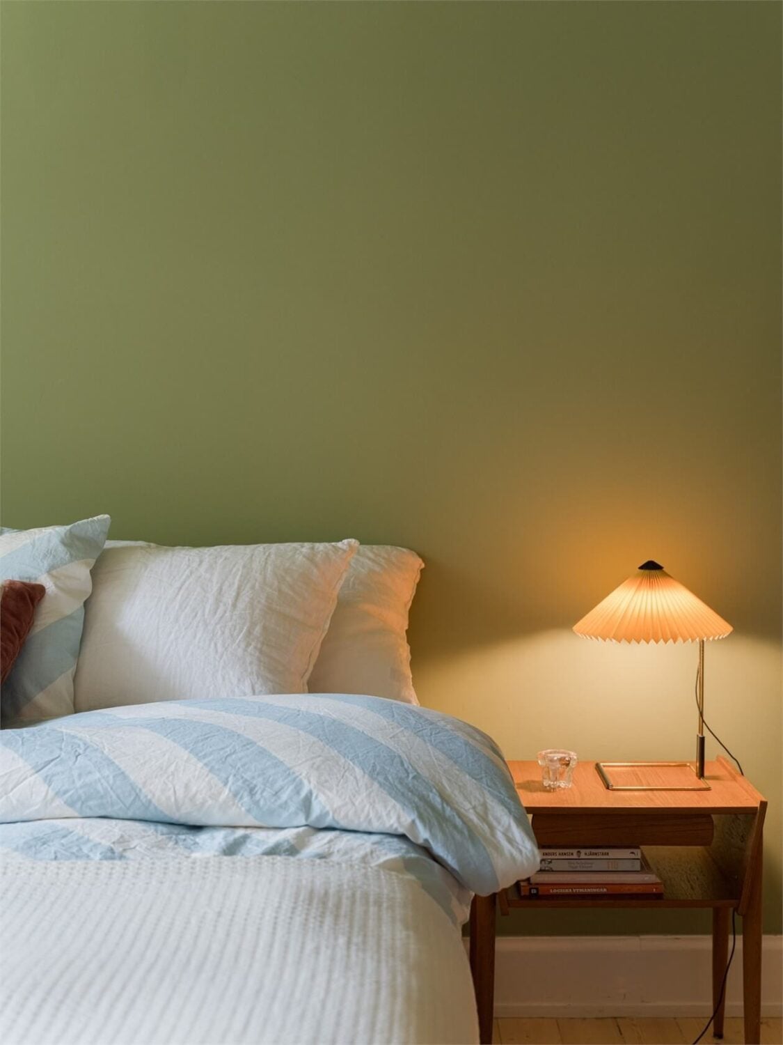 Colorful and Light Rooms in a Swedish One-Bedroom Apartment 14 bedroom detail green wall