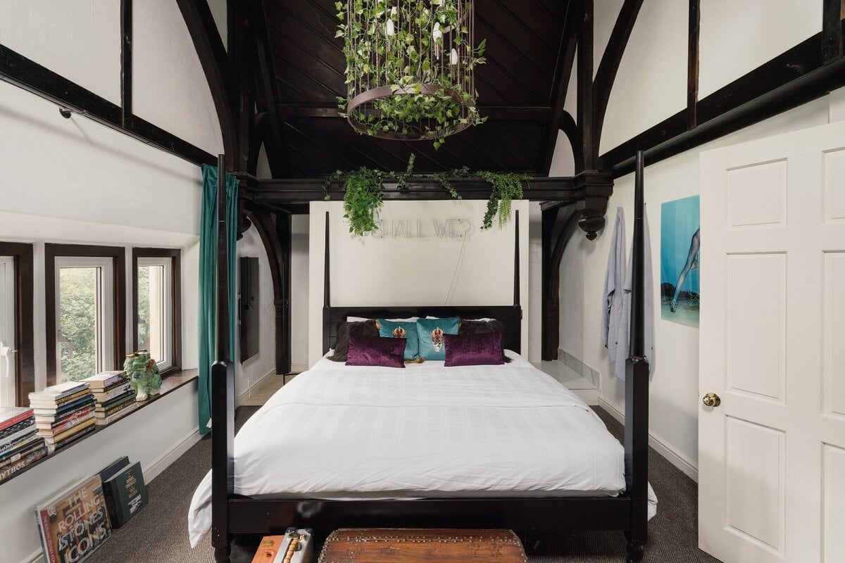 A Colorful Gothic-Style School Conversion in England 11 bedroom high ceilings black wooden beams