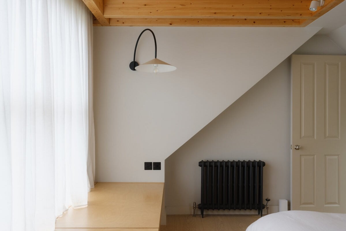 Nature-Inspired Colors in an Extended East London Home 24 bedroom slanted ceiling wooden beam
