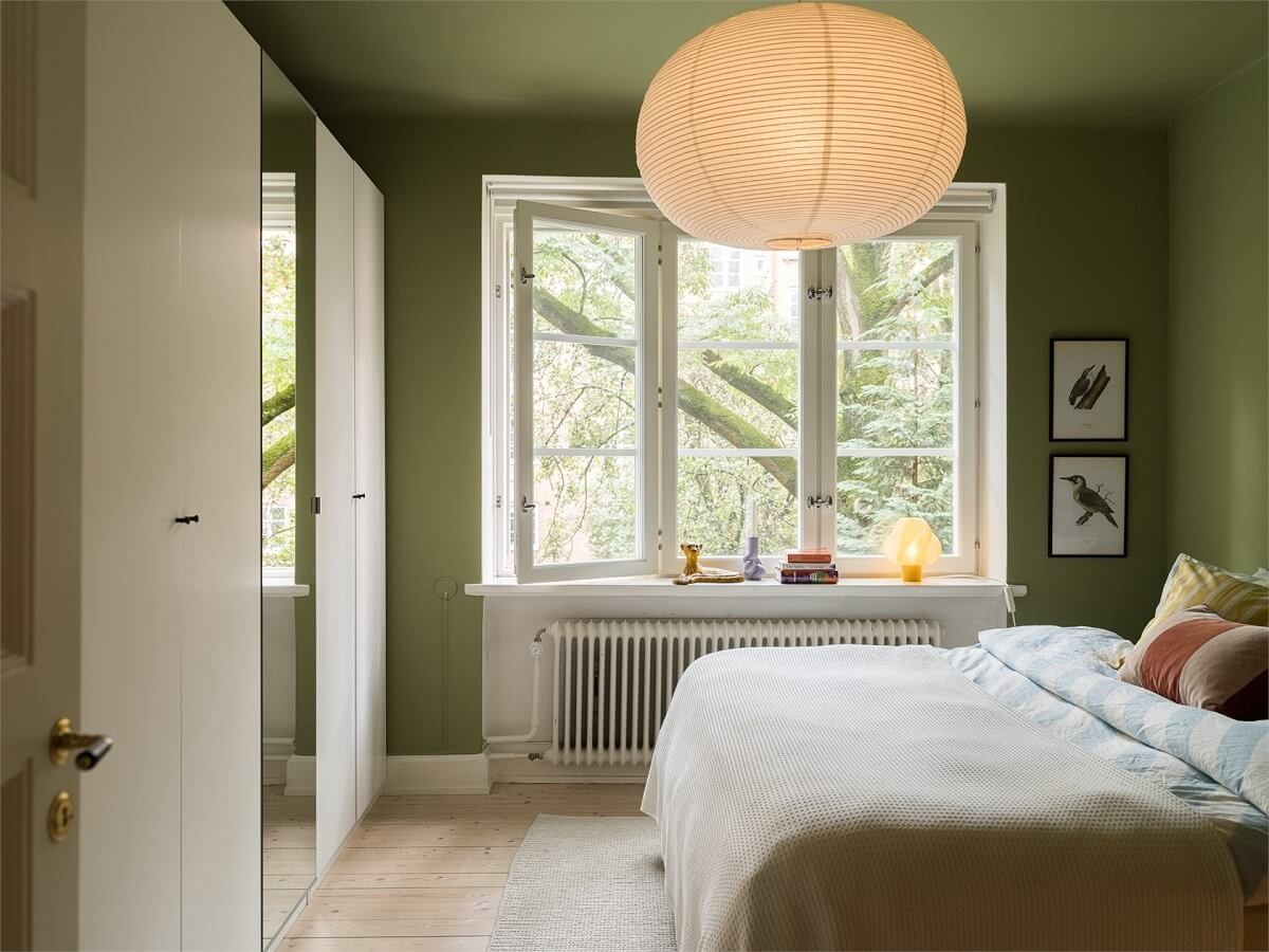 Colorful and Light Rooms in a Swedish One-Bedroom Apartment 13 bedroom with color drenched green walls and ceiling