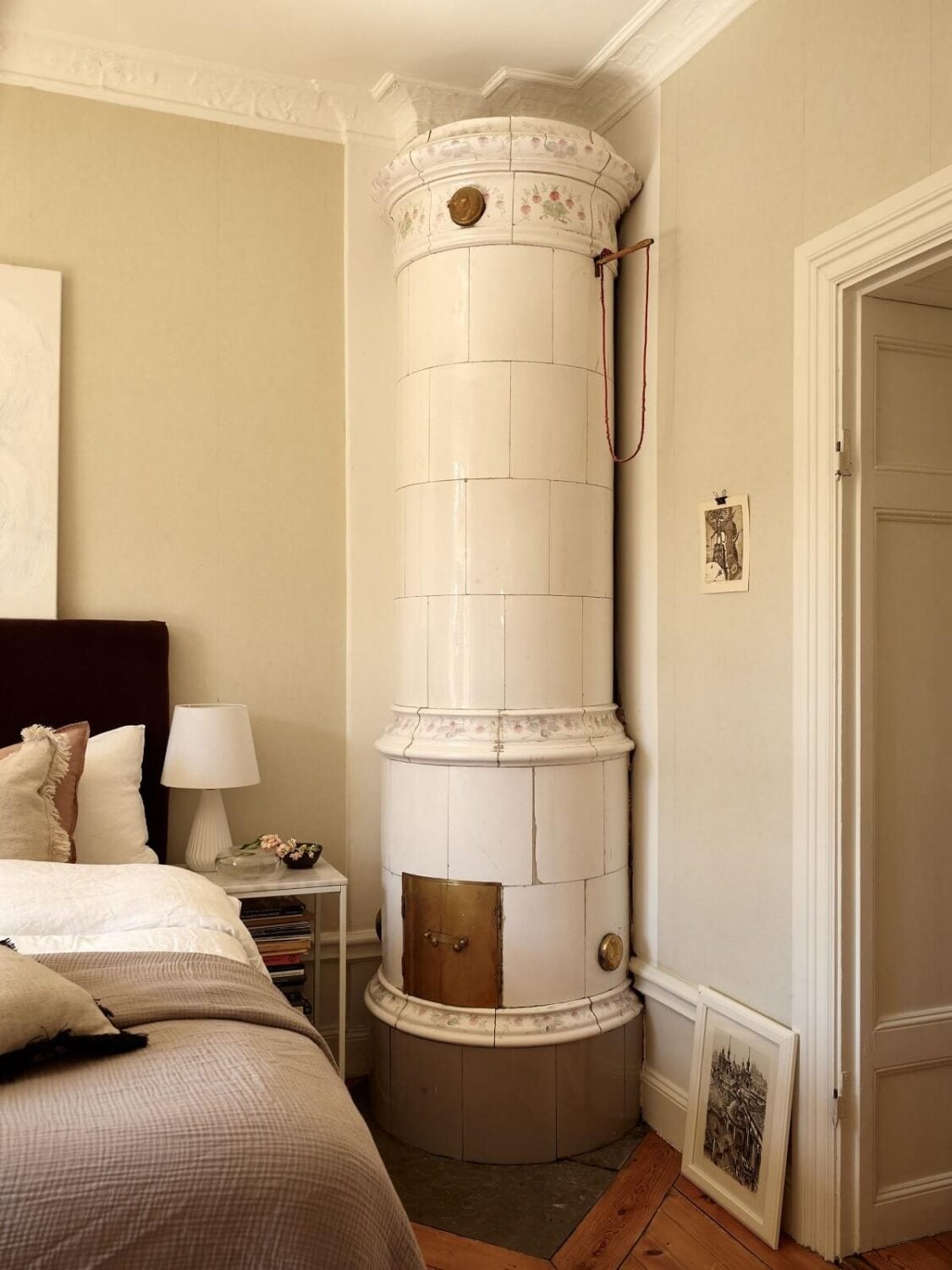 Period Features and Light Colors in a One-Bedroom Apartment 9 bedroom with round tiled fireplace