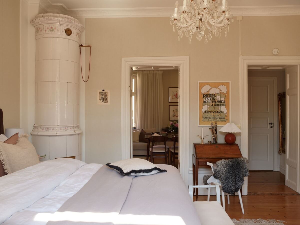 Period Features and Light Colors in a One-Bedroom Apartment 16 beige bedroom with wooden floor and fireplace Period Features and Light Colors in a One-Bedroom Apartment