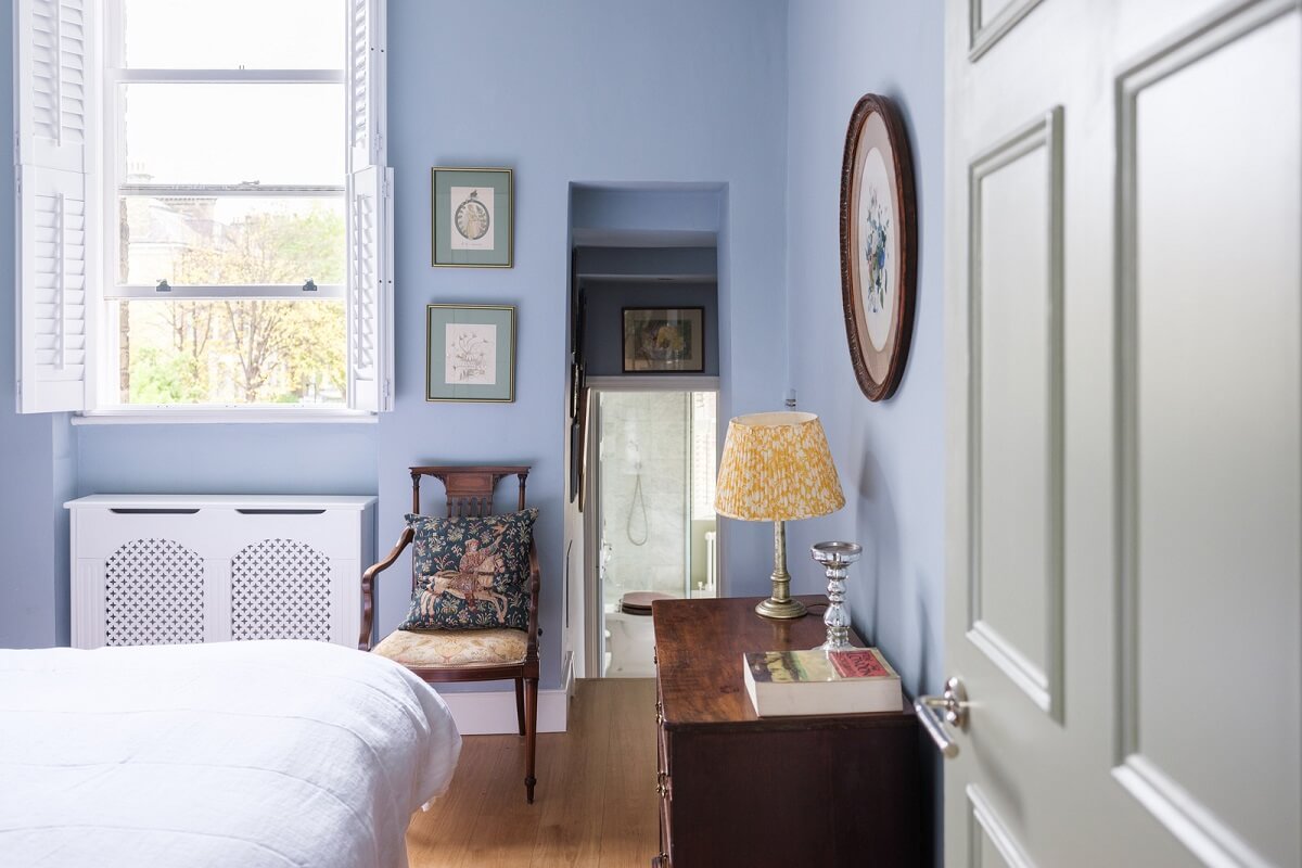 A Beautiful One-Bedroom Apartment with Plants and Period Features 11 blue bedroom with high window