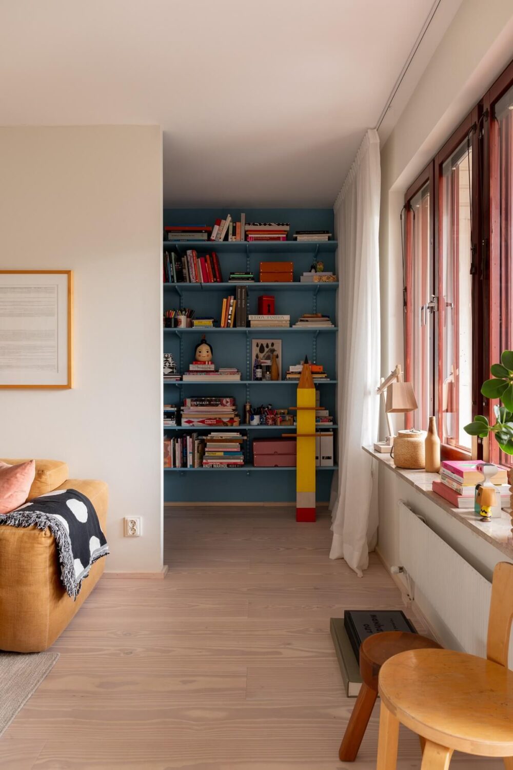 A Light and Modern Stockholm Apartment with Cheerful Color Accents 12 blue bookshelves