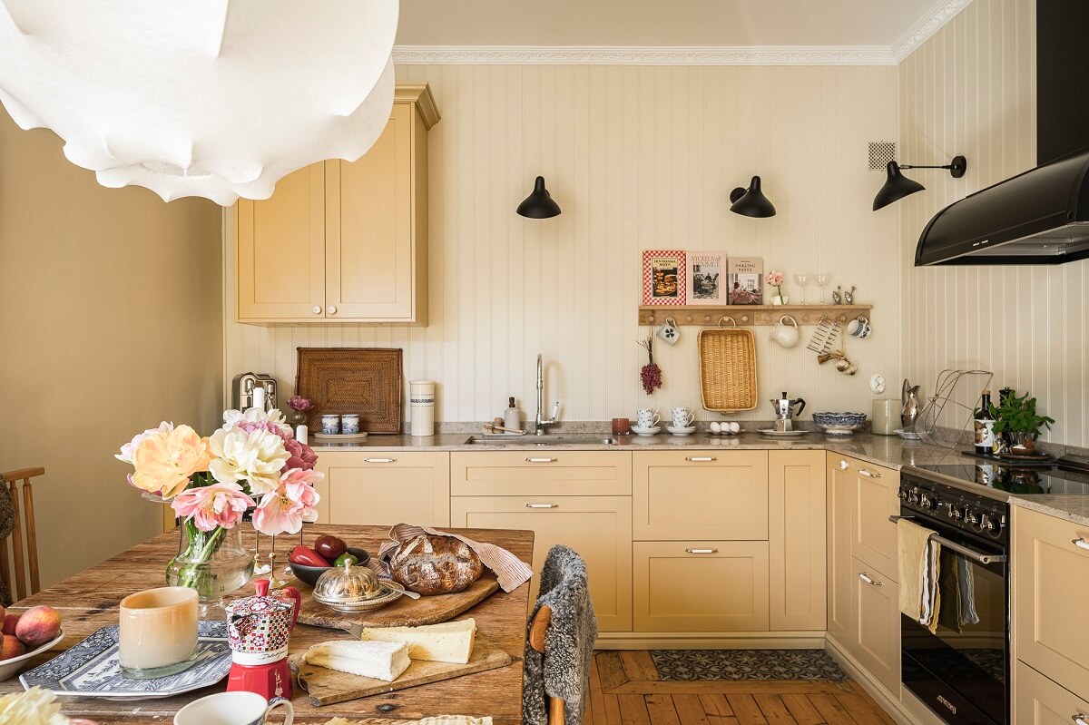 Hannes Mauritzson's Warm Yellow Hygge Apartment in Sweden 23 butter yellow kitchen cabinets