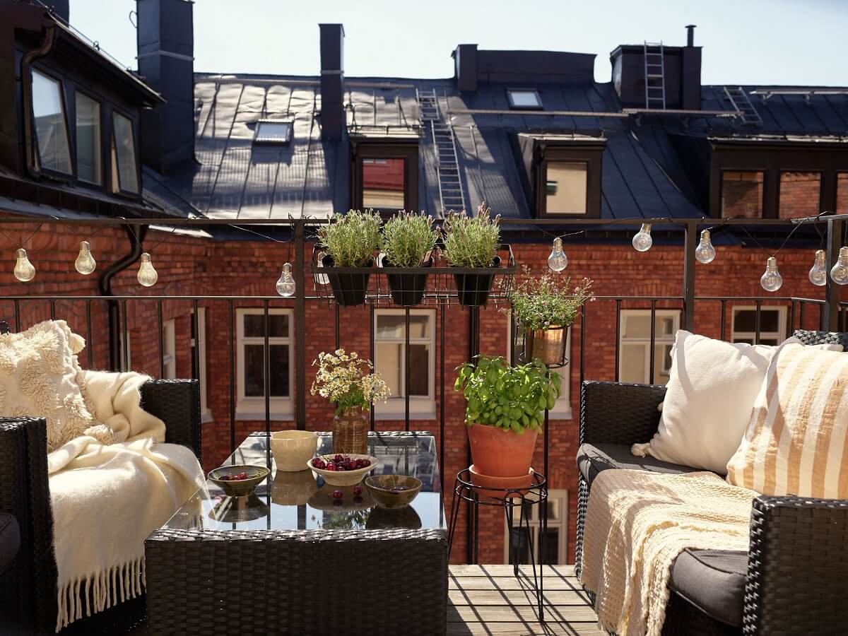 Period Features and Light Colors in a One-Bedroom Apartment 13 courtyard balcony with string lights