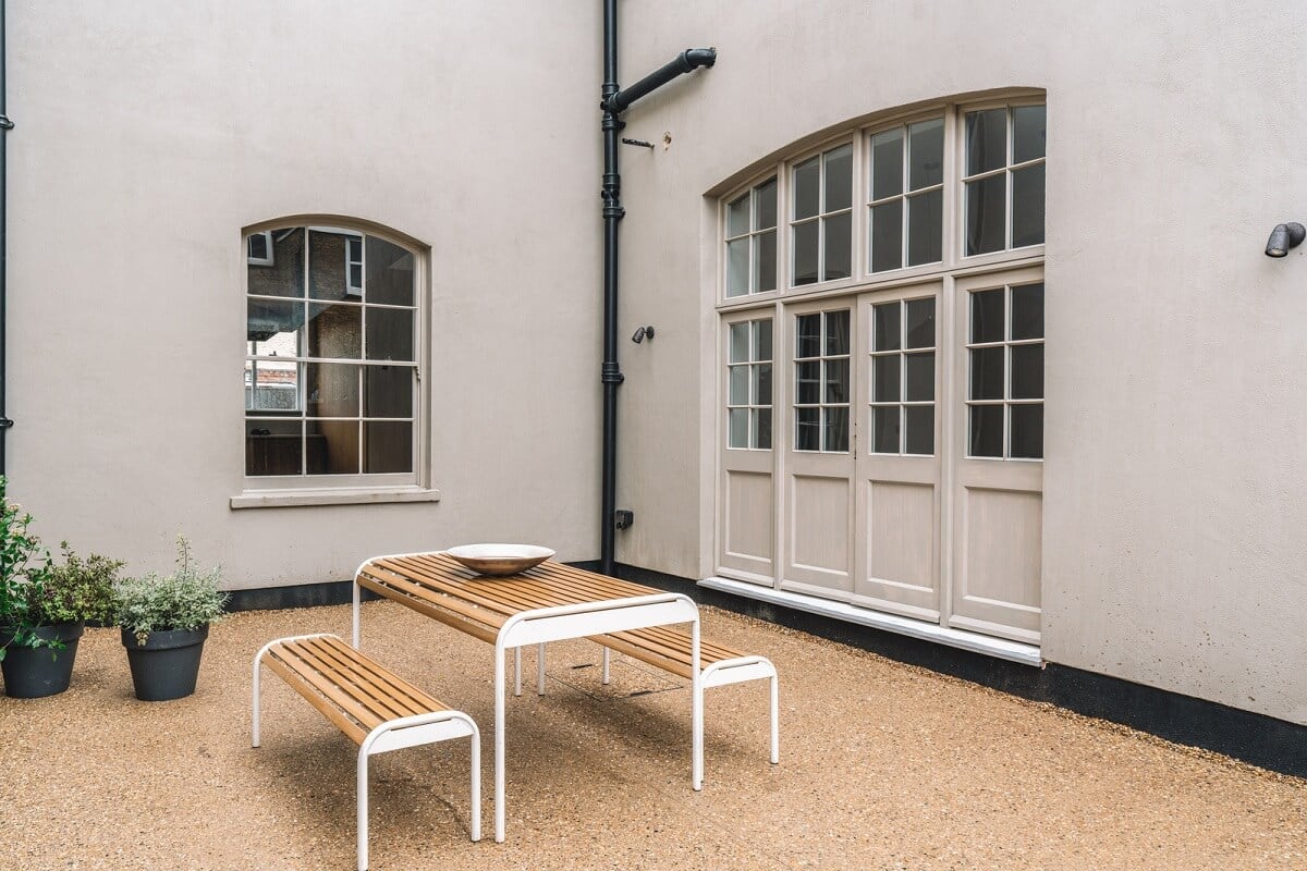 Contemporary Interiors with Limewash Walls in an Old School Building 22 courtyard terrace