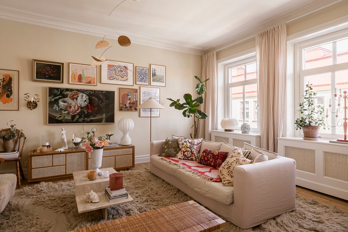Hannes Mauritzson's Warm Yellow Hygge Apartment in Sweden 4 cozy living room large rug gallery wall