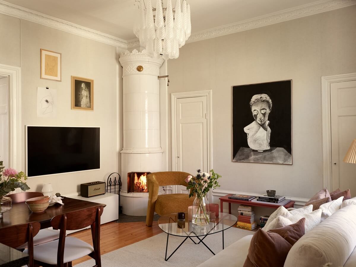 Period Features and Light Colors in a One-Bedroom Apartment 1 cozy living room with ochre yellow chair and fireplace