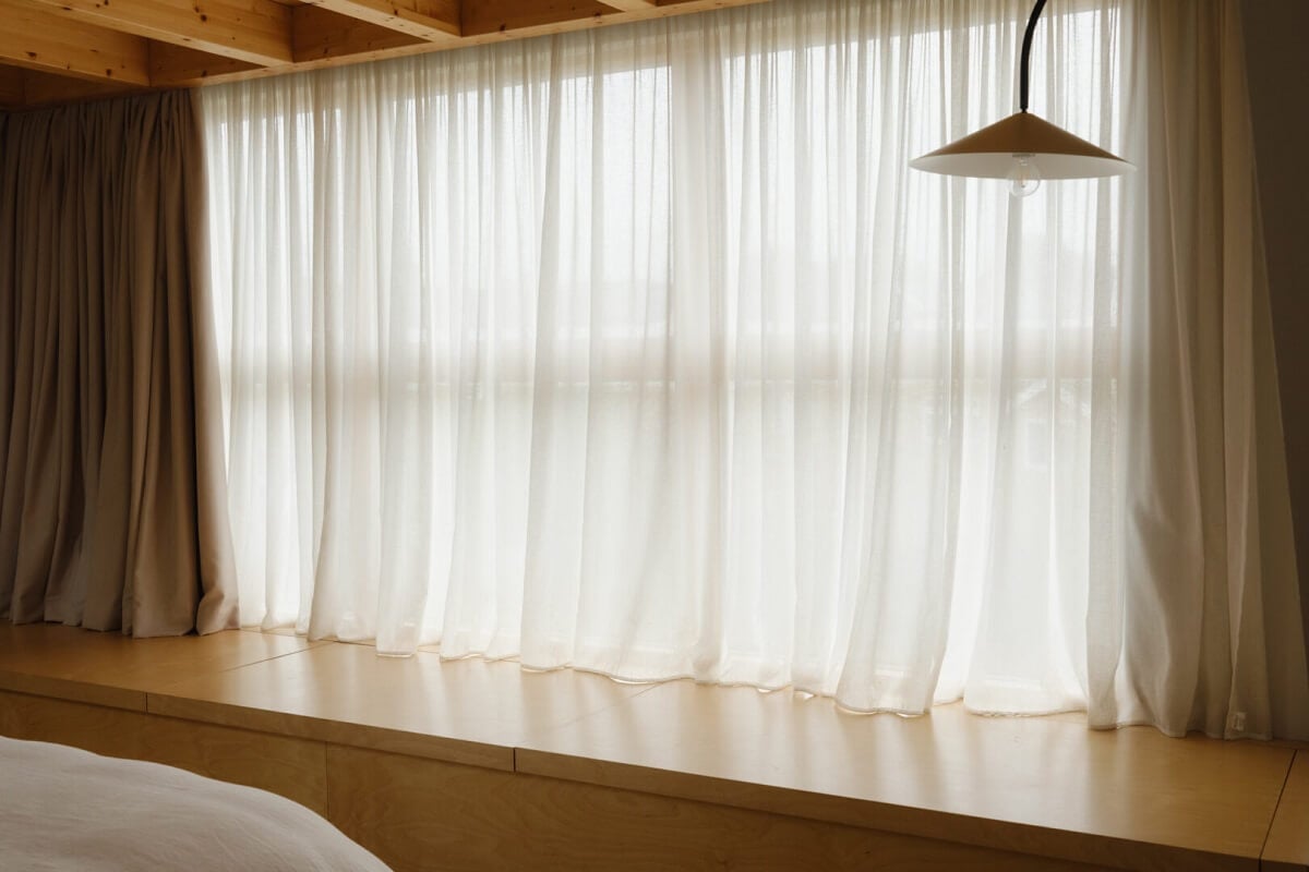 Nature-Inspired Colors in an Extended East London Home 22 cupboards under window bedroom