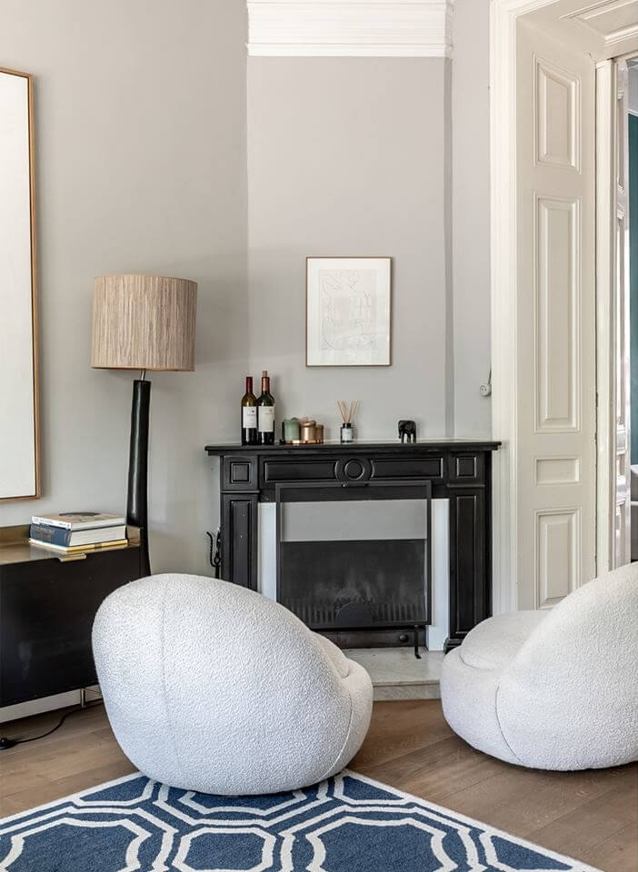 A Beautiful Monumental Villa with Green Color Accents 3 curved chairs in front of fireplace