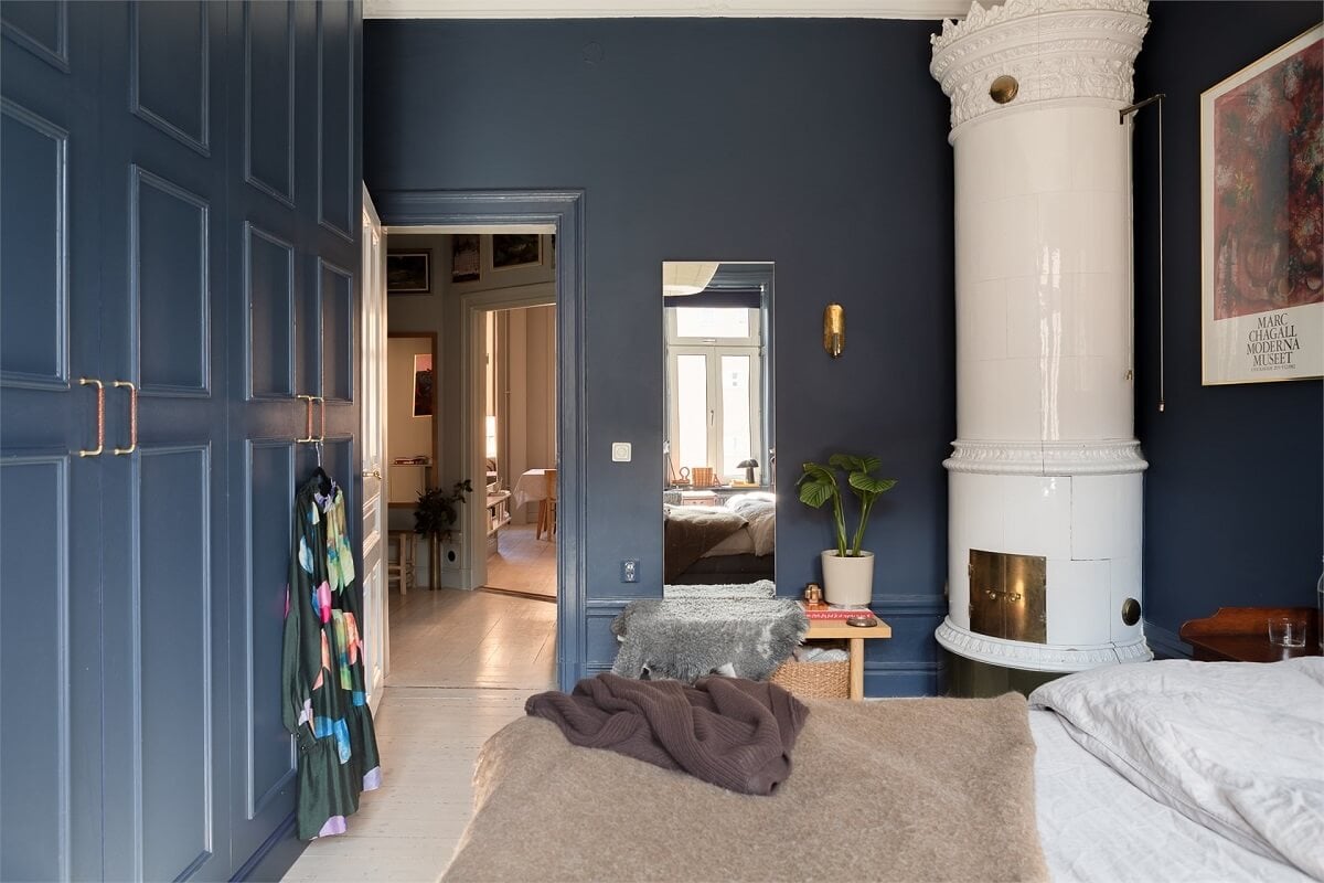 A Turn-of-the-Century Apartment with a Dark Blue Bedroom - Revisited 21 dark blue bedroom with white fireplace