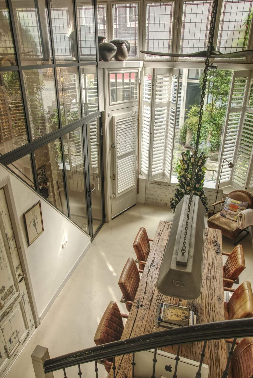 A Charming Amsterdam Townhouse with a Cozy Roof Terrace 3 dining room high ceilings stained glass windows