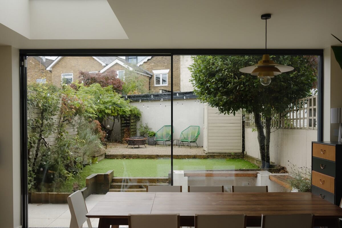 Nature-Inspired Colors in an Extended East London Home 8 dining space with large glass sliding doors