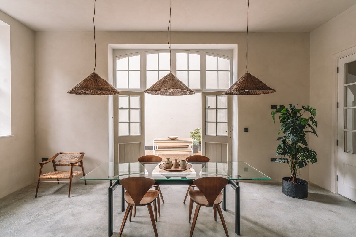 Contemporary Interiors with Limewash Walls in an Old School Building 5 dining space with three pendants and glass doors