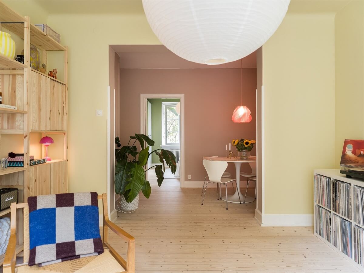 Colorful and Light Rooms in a Swedish One-Bedroom Apartment 4 double yellow and pink living room with light wooden floor