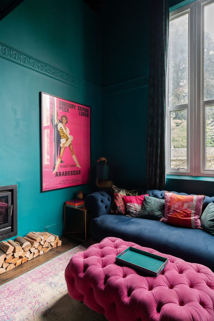 A Colorful Gothic-Style School Conversion in England 7 dramatic teal and pink sitting room