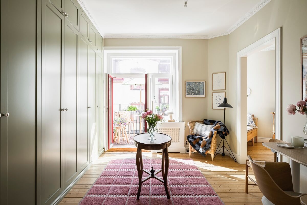 Hannes Mauritzson's Warm Yellow Hygge Apartment in Sweden 32 dressing room with green wardrobes and desk