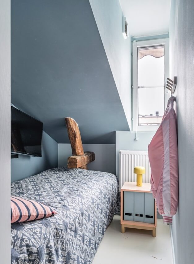 A Small, Colorful Attic Apartment with A Yellow Kitchen 20 dusty blue bedroom slanted ceiling
