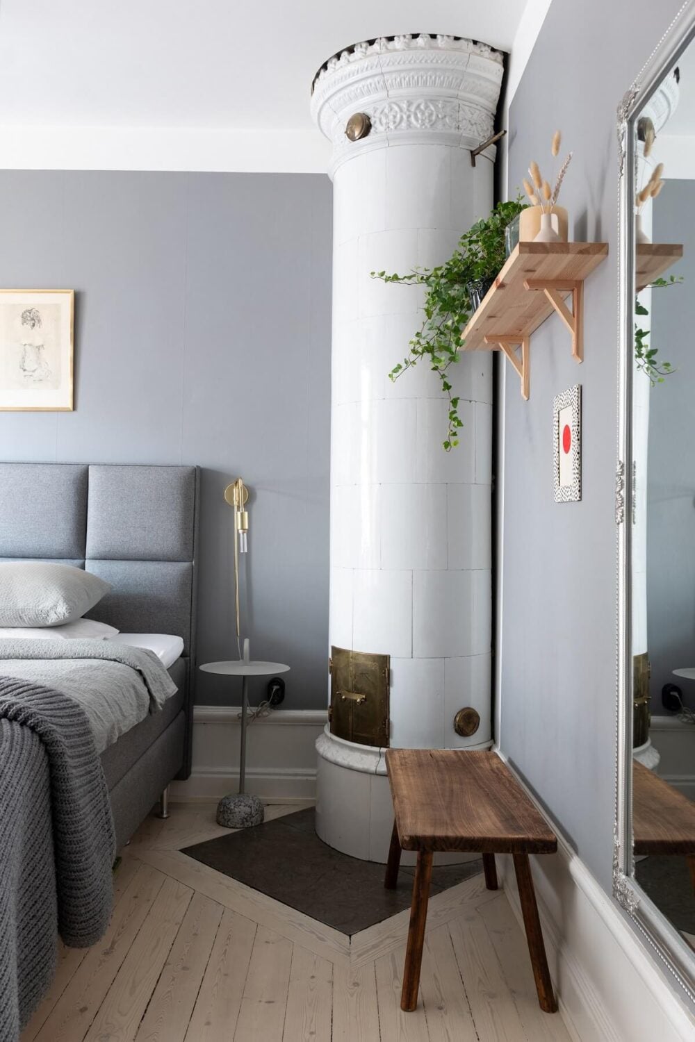 Colorful Art and Furniture in a Stylish Scandi Apartment 20 fireplace in gray bedroom