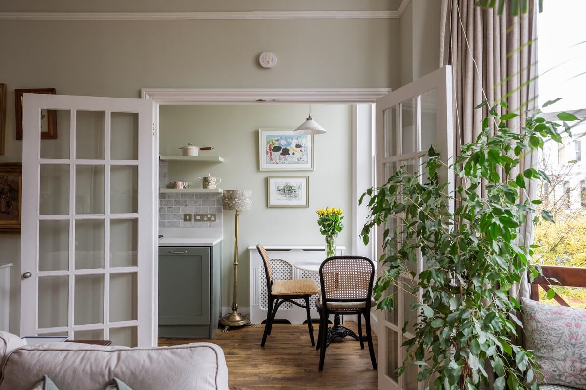 A Beautiful One-Bedroom Apartment with Plants and Period Features 4 glass double doors living room kitchen