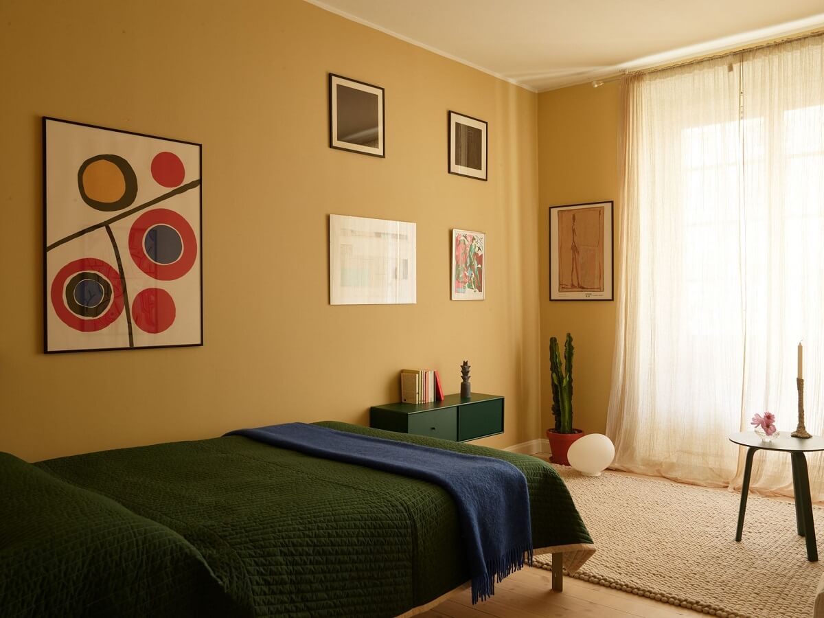 Golden Yellow Walls in a Colorful Swedish Studio Apartment 5 gold wall color studio apartment