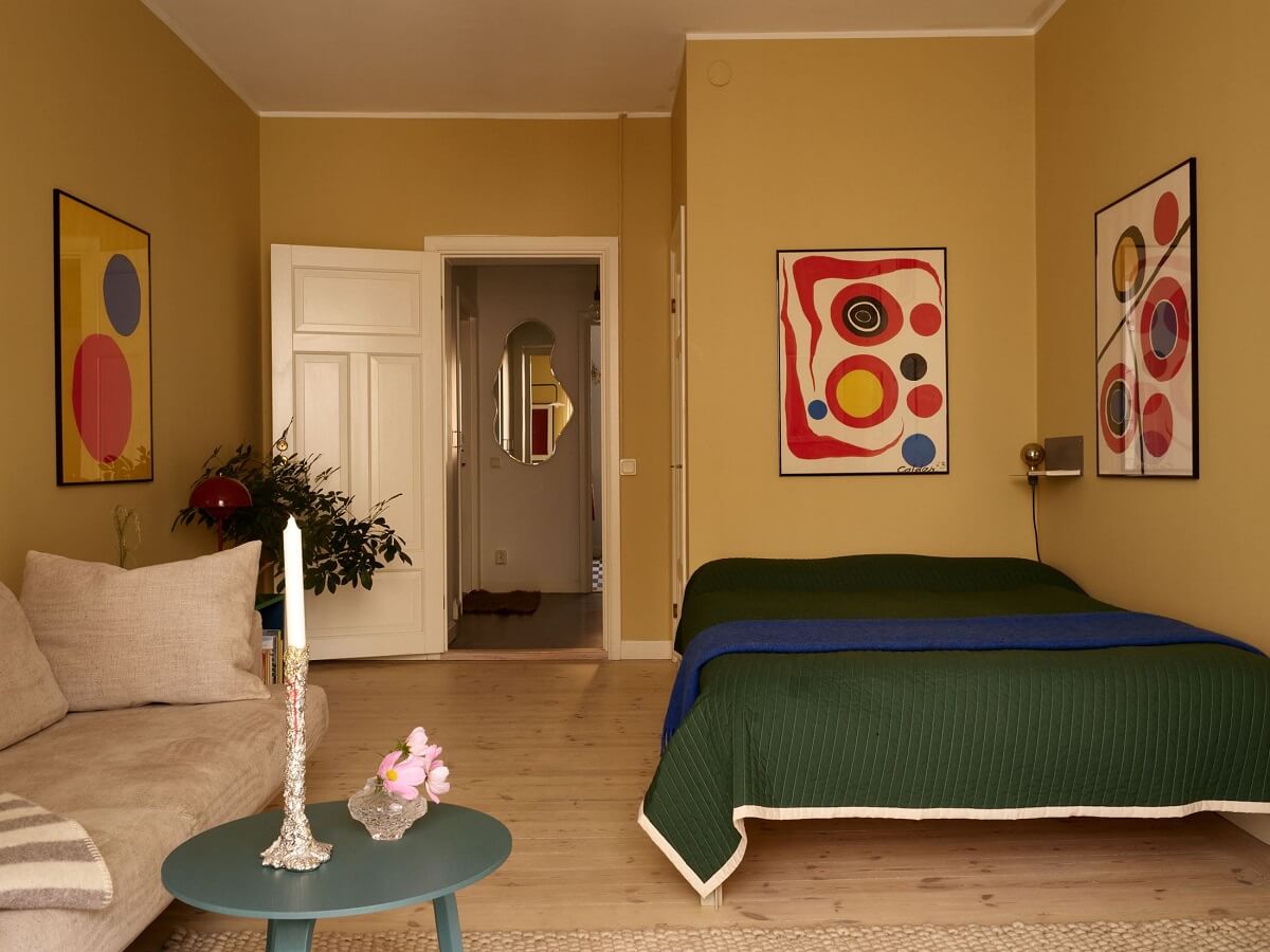 Golden Yellow Walls in a Colorful Swedish Studio Apartment 8 golden yellow studio apartment with green bedding
