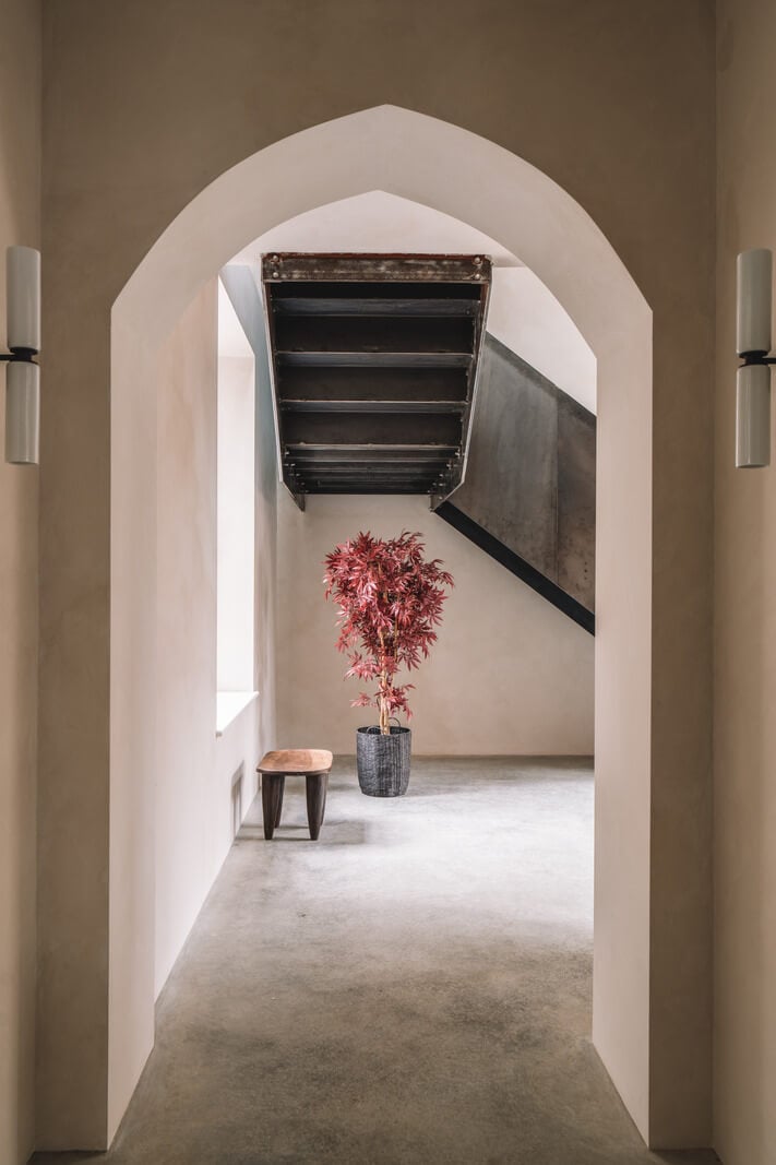 Contemporary Interiors with Limewash Walls in an Old School Building 9 gothic arched doorway
