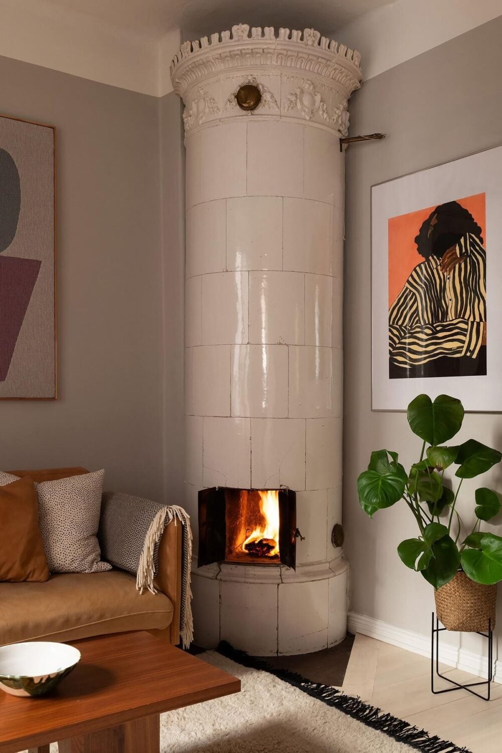 Sober Colors in a Small Renovated Stockholm Apartment 5 gray liivng room with tiled fireplace and earthy sofa