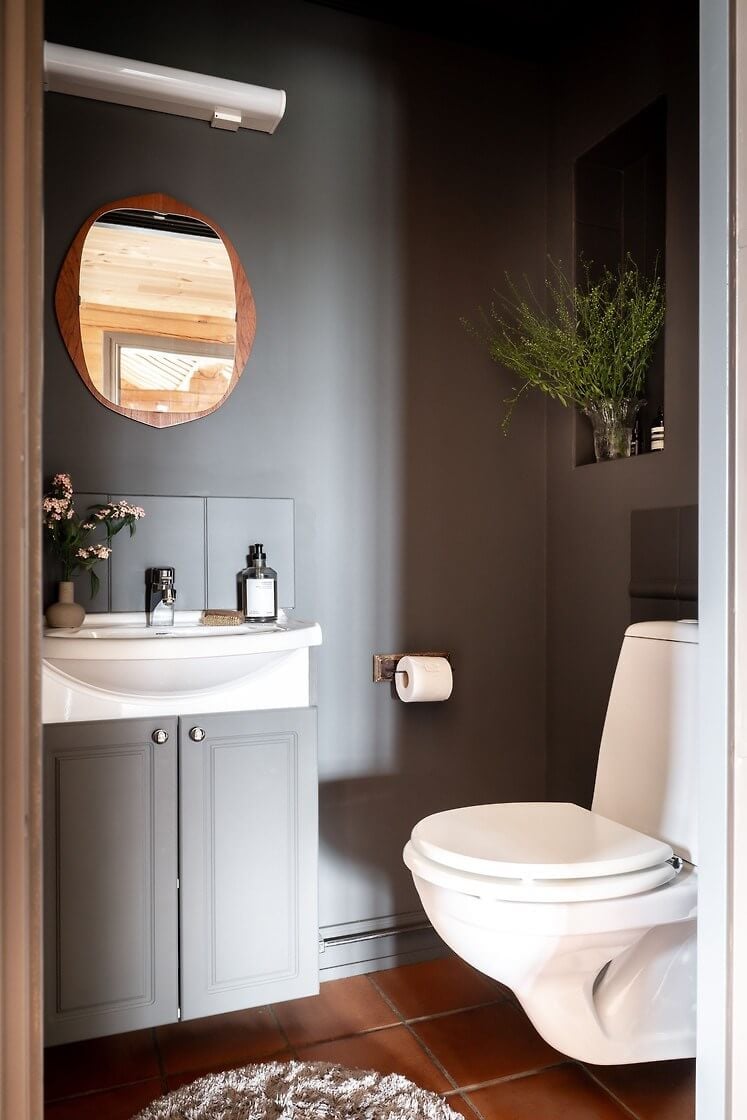 A Warm Scandinavian Log House with a Green Roof 23 gray powder room