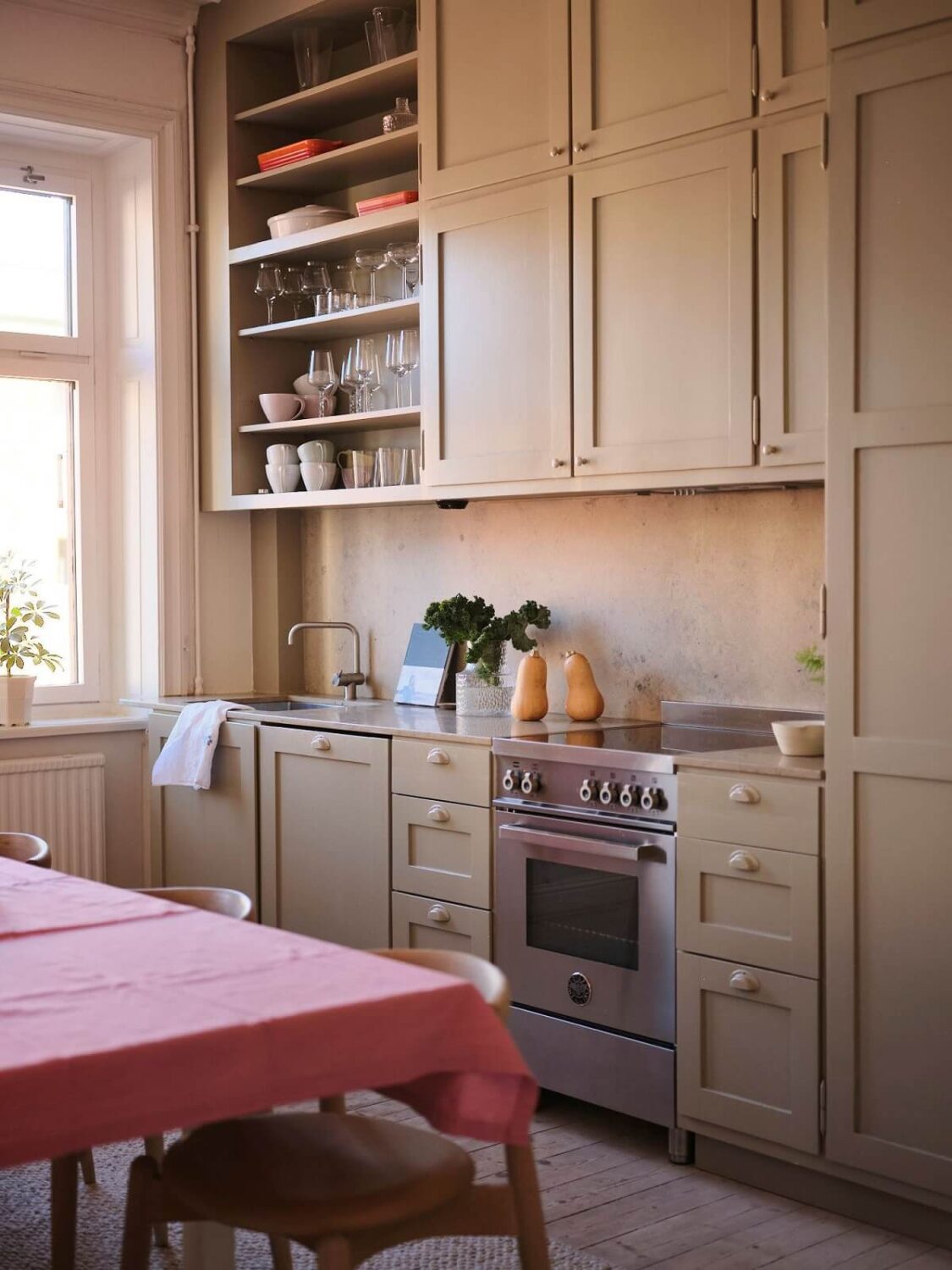A Light Pastel Yellow and Pink Apartment in Stockholm 14 gray scandi kitchen open and closed cabinets