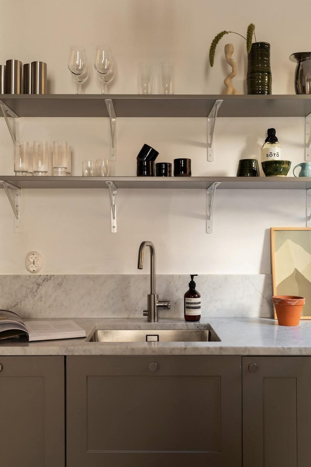 Sober Colors in a Small Renovated Stockholm Apartment 9 gray shaker style cabinets with shelves
