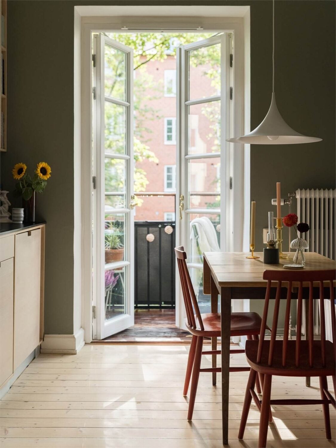 Colorful and Light Rooms in a Swedish One-Bedroom Apartment 10 green kitchen with wooden dining table nordroom