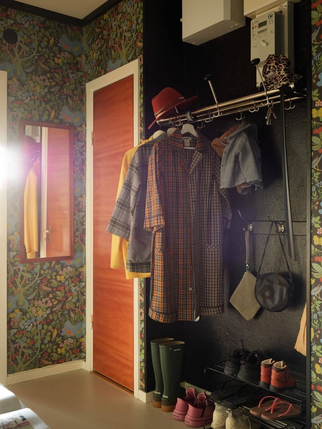 Preserved Midcentury Details and a Red Bedroom in a Stockholm Apartment 19 hallway with coat and shoe storage