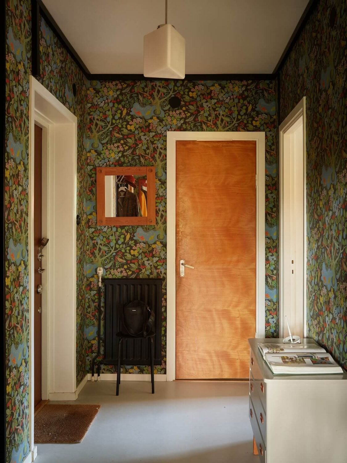 Preserved Midcentury Details and a Red Bedroom in a Stockholm Apartment 18 hallway with green wallpaper