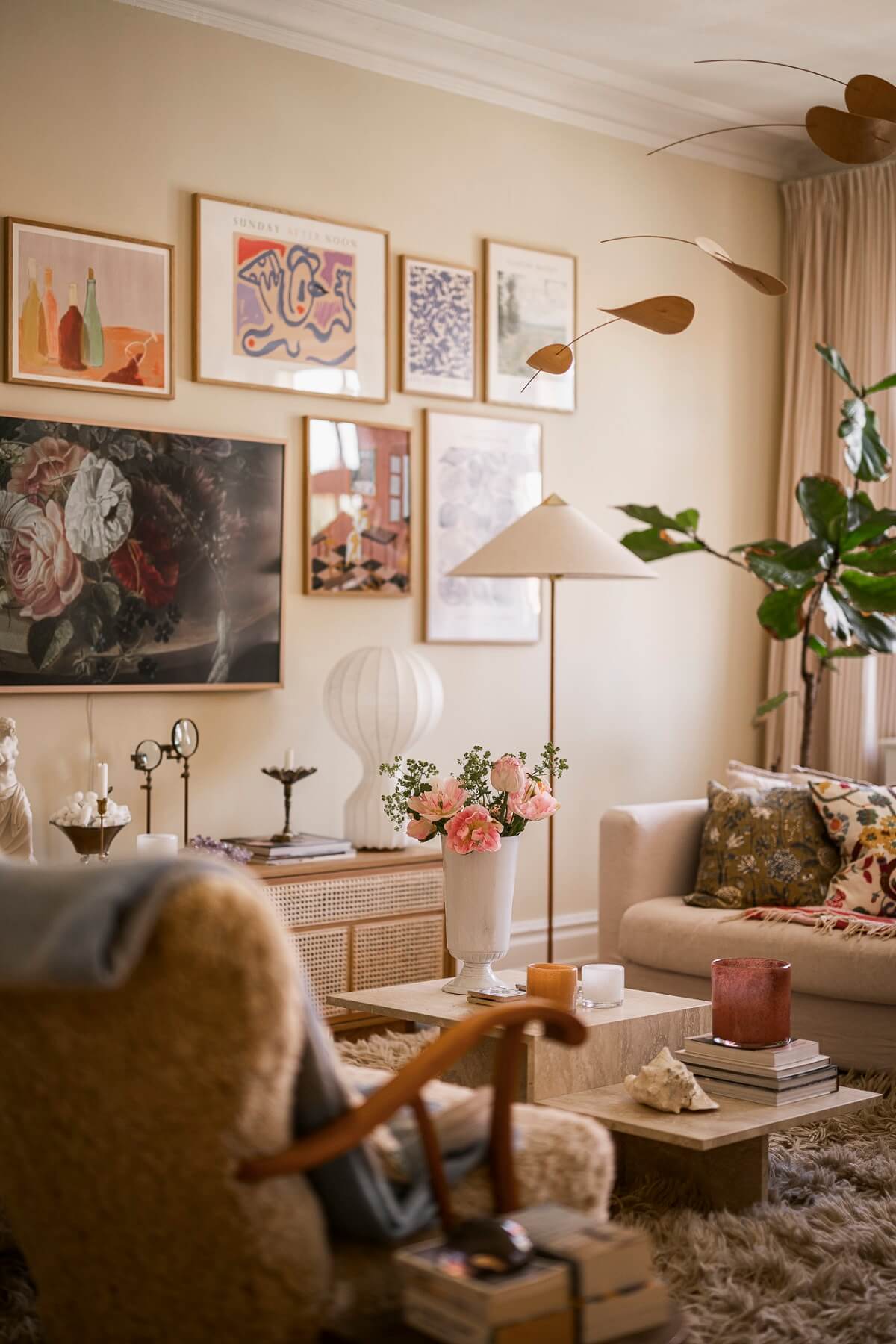 hygge living room with light yellow walls large rug and gallery wall