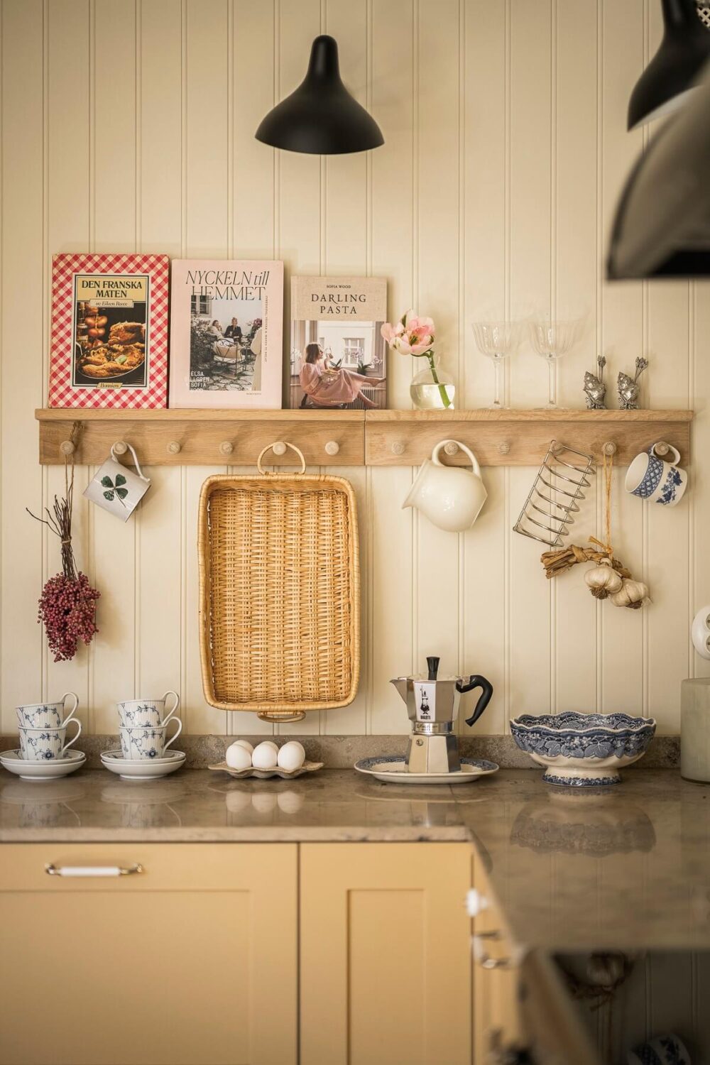 Hannes Mauritzson's Warm Yellow Hygge Apartment in Sweden 18 kitchen detail with mug hooks