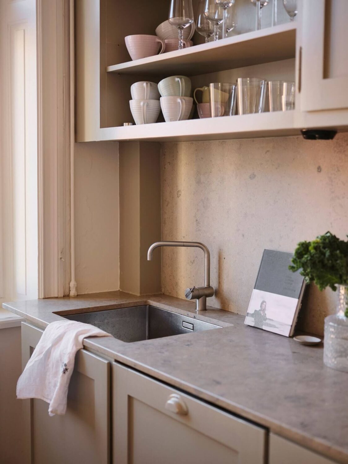 A Light Pastel Yellow and Pink Apartment in Stockholm 13 kitchen detail with open cabinets