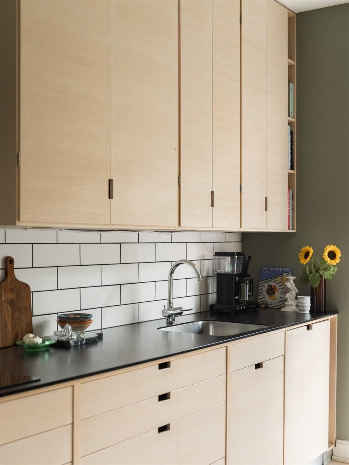 Colorful and Light Rooms in a Swedish One-Bedroom Apartment 9 kitchen detailwhite backsplash tiles
