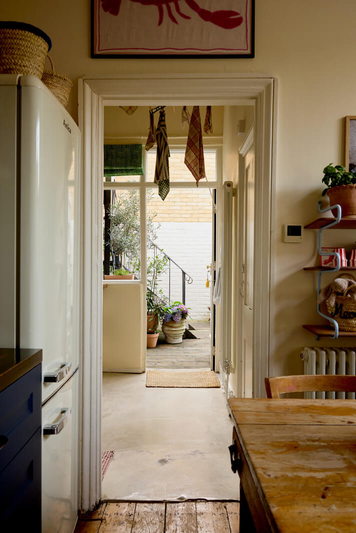 A Beautiful Color Palette in a Victorian London Apartment 9 kitchen view into hall