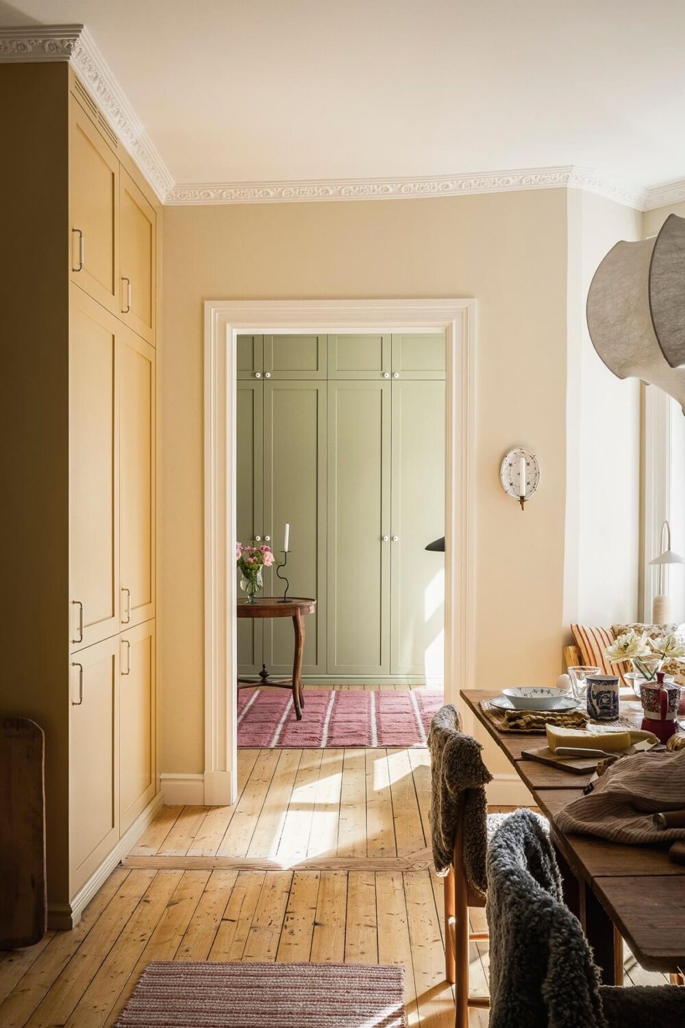Hannes Mauritzson's Warm Yellow Hygge Apartment in Sweden 29 kitchen view into home office