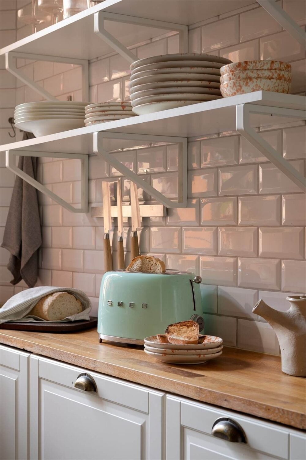 Nature-Inspired Colors in a Charming Stockholm Apartment 12 kitchen white tiles and shelves